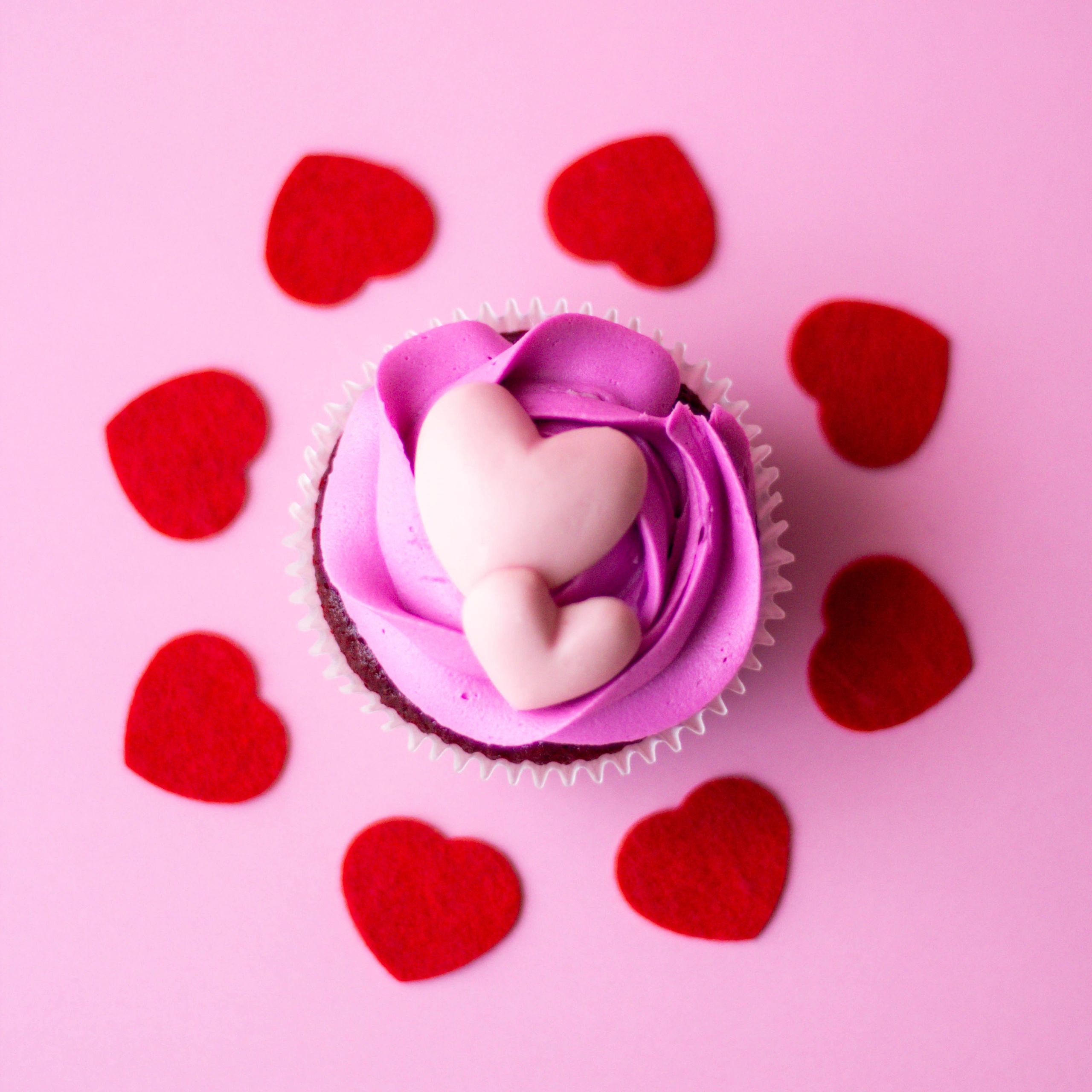Pink iced cupcake with heart decorations